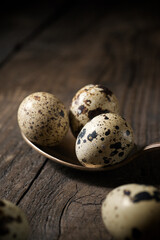 Quail eggs on a wooden table.