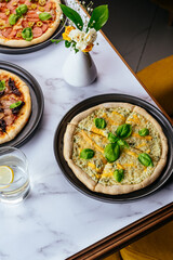 pizza four cheeses on a marble table