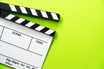 movie clapper on green table background ; film, cinema and video photography concept