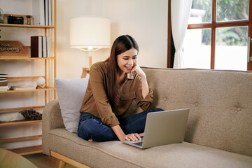 Female entrepreneur reading new business project and typing data