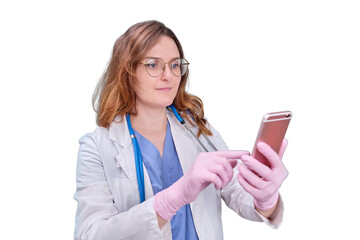 Woman doctor with a phone in her hand on a white uniform, isolated on a white background.