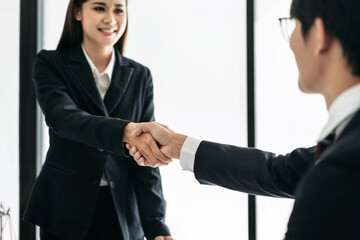 Male lawyer shaking hands with client after discussing deal of a