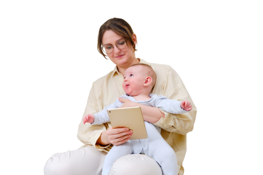 Happy woman mother with infant baby watching in digital tablet while sitting on home sofa in living room, isolated on a white background. Kid aged six months