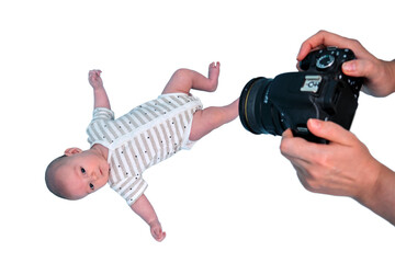 A photographer takes pictures of a newborn baby with a camera in studio, isolated on a white...