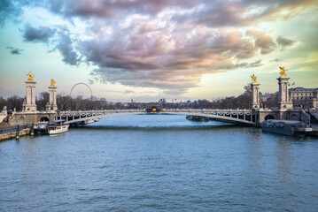     Paris, the Alexandre III bridge on the Seine, with houseboats on the river, sunset 