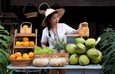 With a natural assortment of fruits, indigenous Asian women greet visitors to the farm stay....