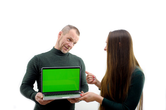 rear view of businessman looking at laptop with green screen in office. man showing laptop chroma key High quality photo