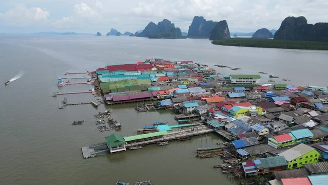 Aerial drone view flying over the floating fishing village at Ko Panyi (or Koh Panyee) one of travel destination in Phang Nga Bay, Phang Nga province, Thailand. 4K footage video
