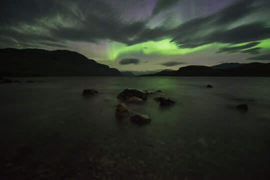 Northern lights shine over lake Langas at STF Saltoluokta Fj&Atilde;&curren;llstation, Kungsleden trail, Lapland, Sweden