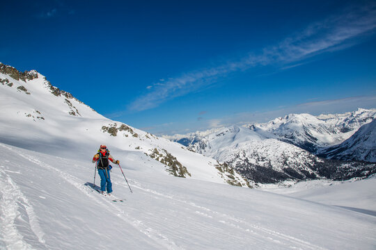 A skier descends to a notch during the Spearhead Traverse in the Coast Mountains of British Columbia, Canada.