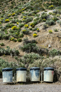 Four garbage cans in row, Death Valley, California, USA