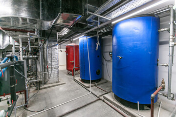 Huge industrial boiler services and air handling unit in the ventilation plant room with ductworks...