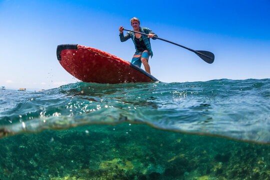 Sup surfing in tropical water.