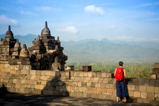 Tourist Exploring Borobudur Temple In Yogyakarta, Java Island, Indonesia