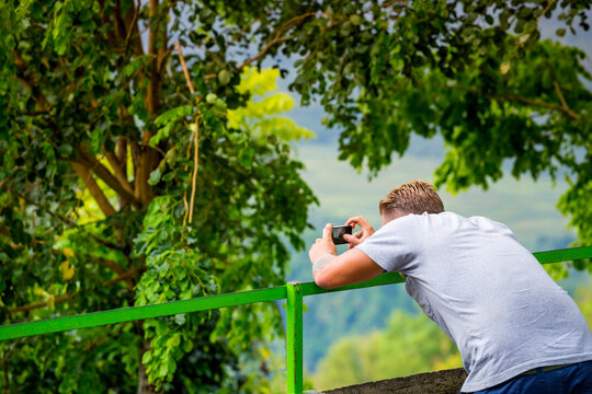 Young Man Taking Picture Using A Mobile Phone At Java, Indonesia