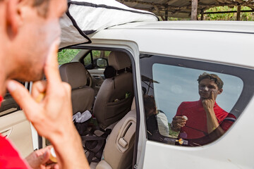 Man applying suntan lotion to face, Sumbawa, Indonesia