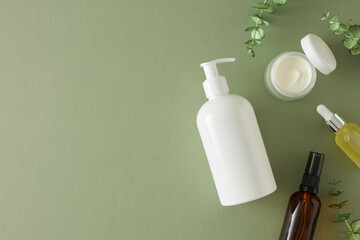 Organic skincare concept. Flat lat mockup of cosmetic tubes, dropper bottle, cream jar, amber pump...