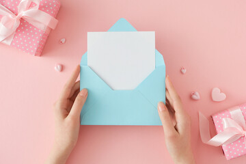 Woman day present concept. First person top view photo of female hands holding envelope with letter...