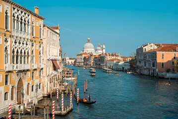 Fototapeta na wymiar The Grand Canal with Venetian Gothic buildings and Basilica di Santa Maria della Salute, the domed baroque church in Venice, Italy