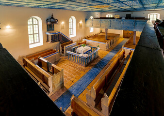 Interior of a medieval church. The inside roof made with blue colored wooden cassettes what decorated with painted clouds. Part of the Orseg national Park in Hungary, Szentgyorgyvolgy village.