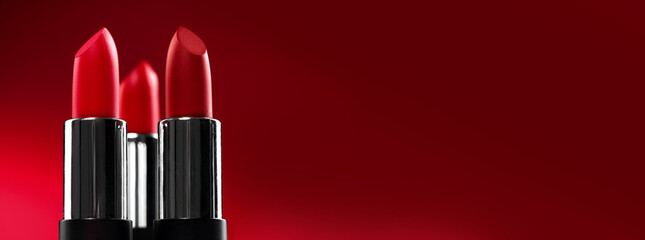 Lipstick. Fashion red colorful Lipsticks over red background. Matt Red lipstick tints palette,...
