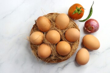 Brown Chicken eggs in a wooden basket. Hen eggs. organic brown eggs online shopping product photography. protein rich food. copy space. weight loss concept. Fitness journey. Anda bhurji ingredients.