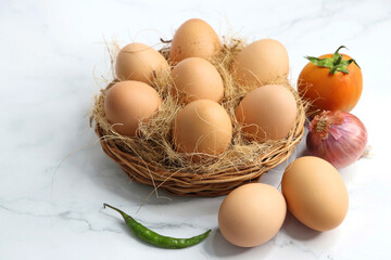 Brown Chicken eggs in a wooden basket. Hen eggs. organic brown eggs online shopping product photography. protein rich food. copy space. weight loss concept. Fitness journey. Anda bhurji ingredients.