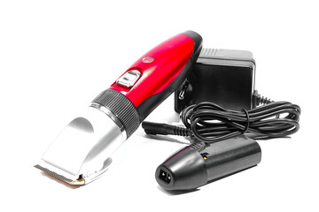 Hair clipper, extra battery, charger on white background