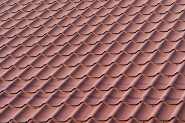 Red metal roof tiles. The texture of shingles