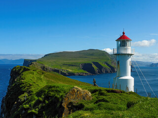 Fototapeta na wymiar Lighthouse on the coast of Mykines island, Faroe islands. 