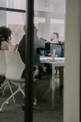 A photo through the window of people having fun during brainstorming