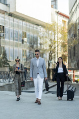Three business people walking