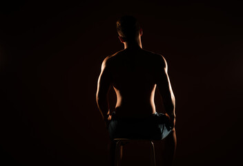 Silhouette of a man sitting