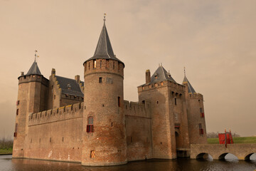 Fototapeta na wymiar Muiderslot castle in Muiden Netherlands 14th century historic building architecture for defence. Fort is now museum and place of interest for tourists to visit and learn Dutch history in Holland