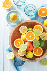 Healthy and fresh mix of citrus fruits in wooden bowl.