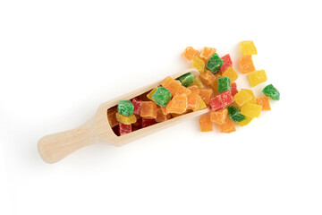 candied fruit in wooden scoop isolated on white