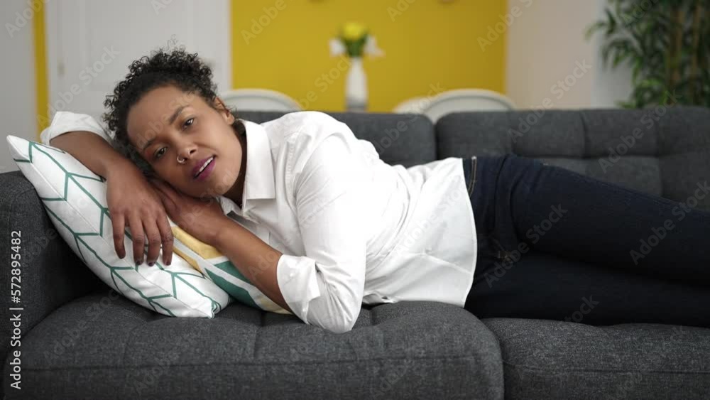 Sticker African american woman lying on sofa sleeping at home