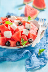 Tasty and sweet watermelon salad with blueberries and mint leaves.