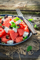 Juicy and fresh watermelon salad with blueberries and nuts.
