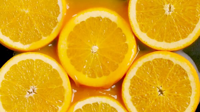 Sliced orange stack into orange juice shooting with slowmotion