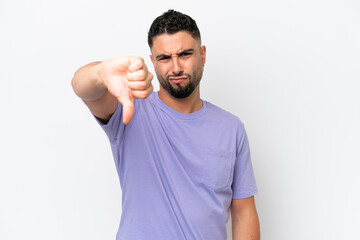 Young Arab handsome man isolated on white background showing thumb down with negative expression