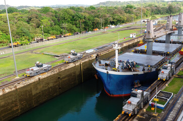 Fototapeta na wymiar Two cargo ship transiting the Miraflores locks in the Panama Canal in Central America