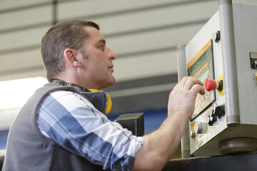 man operating machine in factory