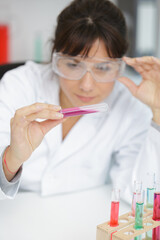 woman in lab write results on notes
