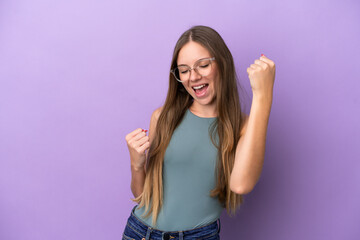 Fototapeta na wymiar Young Lithuanian woman isolated on purple background celebrating a victory