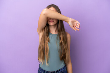 Young Lithuanian woman isolated on purple background covering eyes by hands