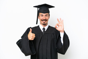 Young university graduate man isolated on white background showing ok sign and thumb up gesture