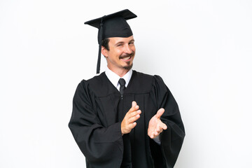 Young university graduate man isolated on white background applauding after presentation in a...