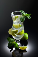 Mojito cocktail with ice, lime, and mint.