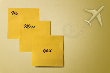 sticky note with the message 'we miss you` placed on a white wall, Perfect for projects related to travel or relationships, this image evokes a sense of longing and communicates the heartfelt message 